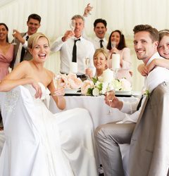 Guests sitting at a table at a wedding