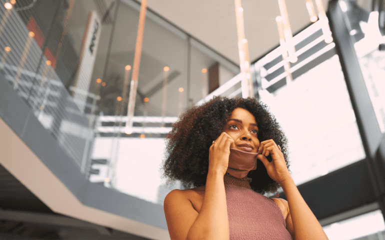 Woman removing her face mask during COVID-19 coronavirus pandemic